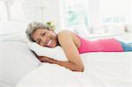Portrait smiling mature woman laying on bed