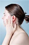 Young woman touching her inflamed ear