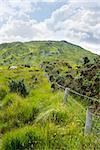 view from a beautiful hiking route the kerry way in ireland of fence leading to rocky mountains