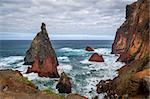 Volcanic rocks and dangerous shores of Atlantoc ocean. Madeira island rocky coast, Portugal.