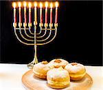 image of jewish holiday Hanukkah with menorah and doughnuts