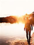 Girl on jetty at sunset