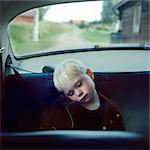 Boy sleeping on back seat of car