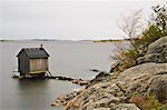 View of small shed on coastline