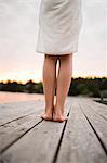 Girls legs on jetty, close-up