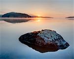 Stones in lake at sunrise, Sweden
