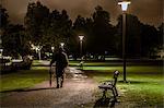 Man walking through park at night, Ronneby, Blekinge, Sweden