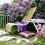 Outdoor furniture in a flowering garden, Sweden.