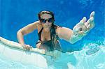 Woman holding out hand in pool