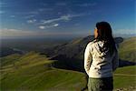 woman looking at view from hill