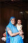 Smiling woman holding toddler outdoors