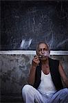 Man smoking pipe on city street
