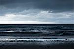 Waves crashing on sandy beach