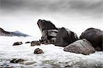 Waves washing over rocks on beach