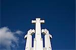 Low angle view of crosses and blue sky