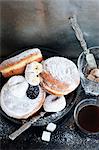 Plate of donuts with coffee and sugar