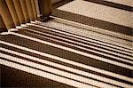 Window blinds casting shadow on carpet