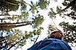 Woman with trees, low angle view