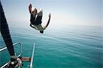 Man jumping head first into the sea