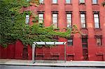 Bus stop and red brick building, New York City, USA