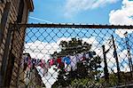 View through wire fence to laundry on clothes line