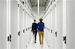 Two employees walking away in data storage room