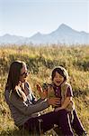 Mother and toddler playing in long grass