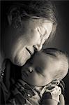 Portrait of grandmother holding baby granddaughter