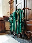Green religious robes hanging in church interior