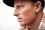 Close up portrait of young man in baseball cap