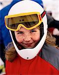 Girl wearing skiwear and goggles smiling, portrait