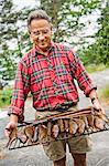 Senior man with smoked fish