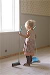 Girl sweeping floor