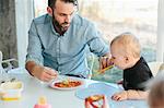 Father with toddler at table