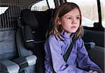 6 year old girl sitting in a car staring dreamily, Germany