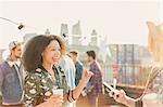 Enthusiastic young women enjoying rooftop party