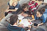 College students studying on bed