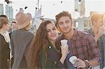 Portrait smiling young couple drinking at rooftop party