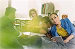 Portrait smiling college student studying with friends on bed