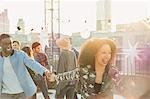 Playful young couple at rooftop party