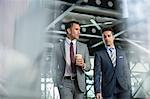 Corporate businessmen walking with coffee