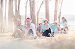 Smiling senior adults practicing yoga in sunny park