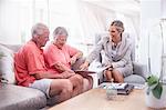 Financial advisor discussing paperwork with senior couple