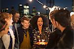 Young friends celebrating birthday at rooftop party