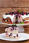 Mulberry and red currant cake with yogurt and whipped cream. Shallow dof