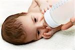 Cute newborn baby eating from the plastic bottle
