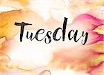 The word "Tuesday" written in black paint on a colorful watercolor washed background.