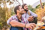 Men having coffee together in forest, Deer Park, Cape Town, South Africa