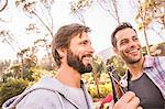 Two men relaxing with beer in forest, Deer Park, Cape Town, South Africa