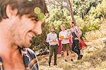 Close up of man camping with friends in forest, Deer Park, Cape Town, South Africa